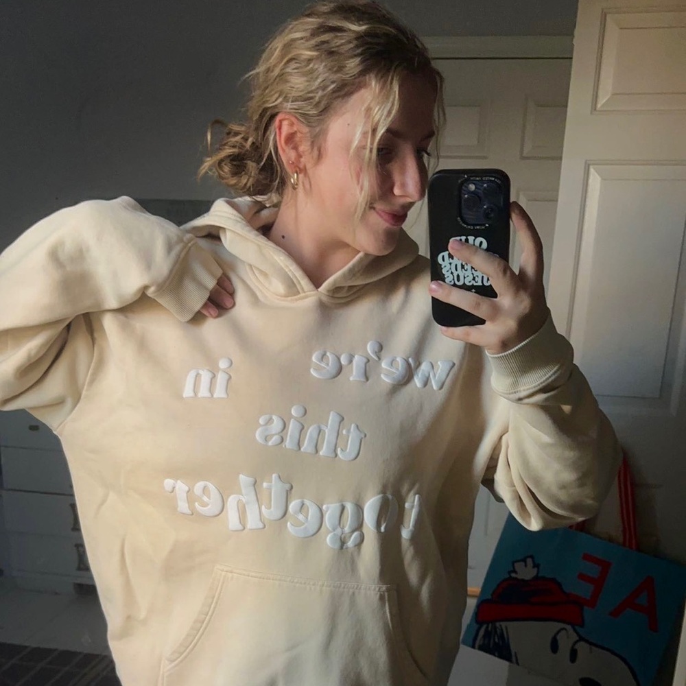 Cream and white hoodie with puff letters "we're in this together" slogan